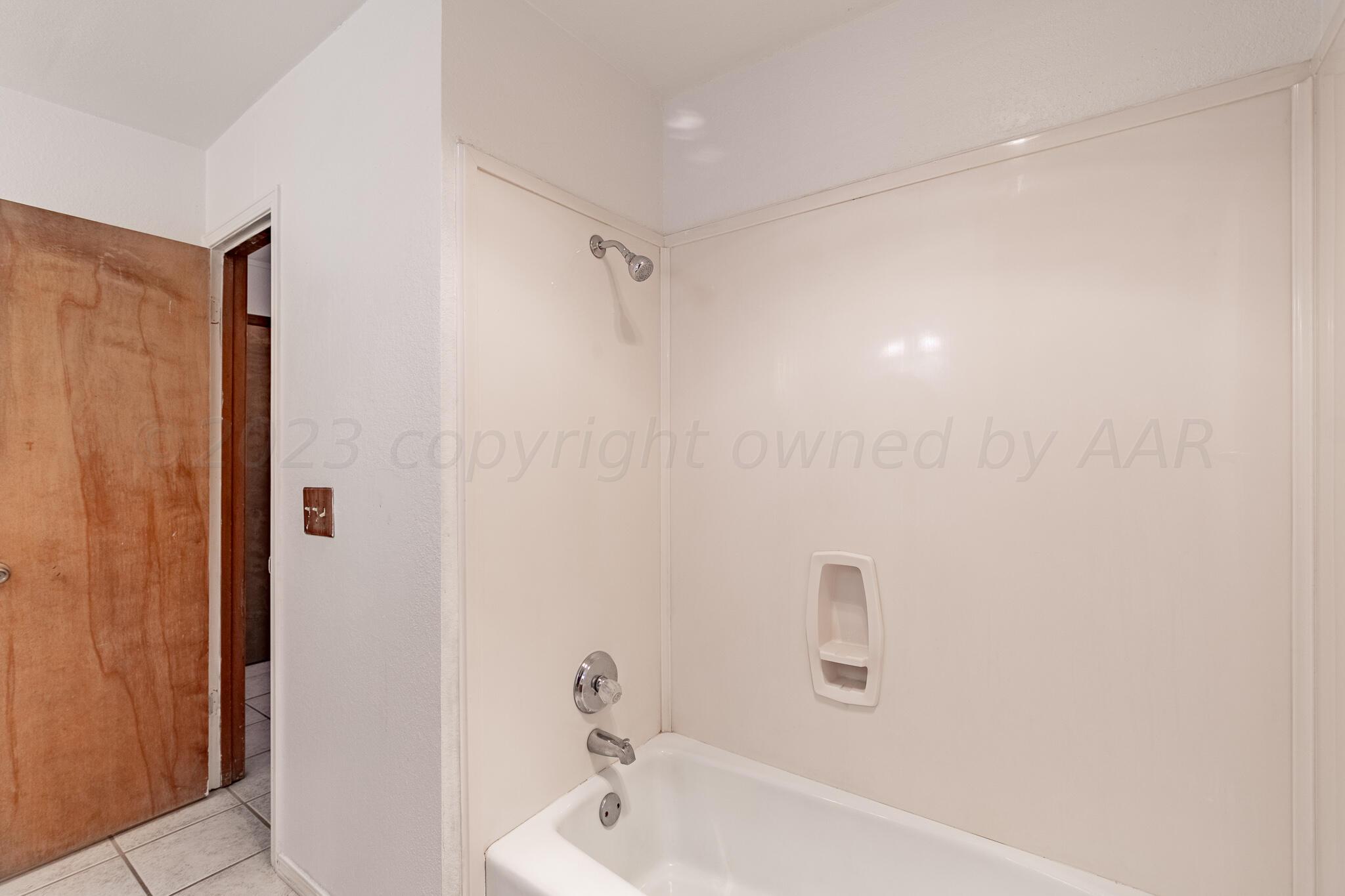 3103 Southwest 27th Avenue Amarillo, TX 79109 - Photo 17 of 21 a bathroom with a bathtub and shower