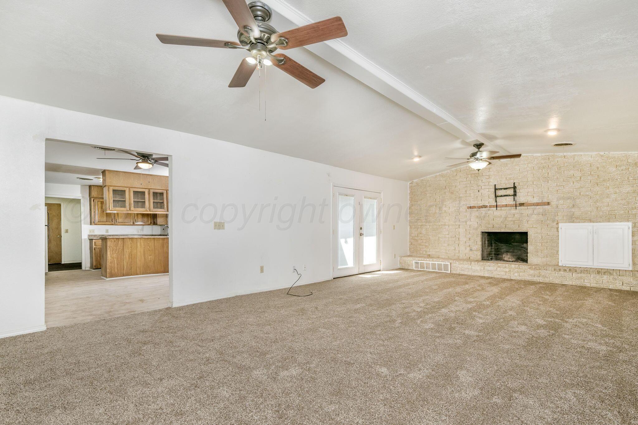 3103 Southwest 27th Avenue Amarillo, TX 79109 - Photo 5 of 21 en view interior of a house with an empty space and a fireplace