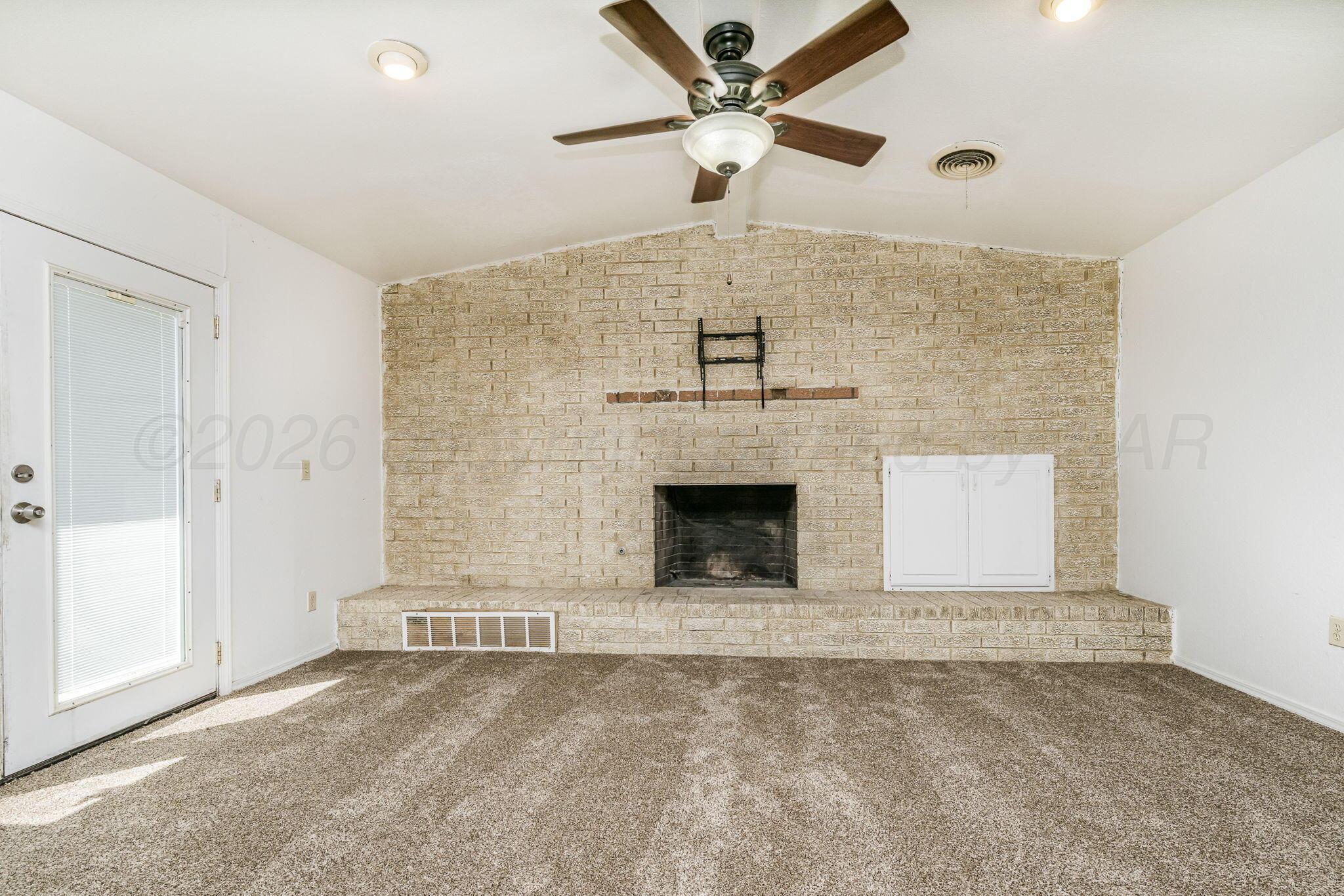 3103 Southwest 27th Avenue Amarillo, TX 79109 - Photo 6 of 21 a view of an empty room with a fireplace