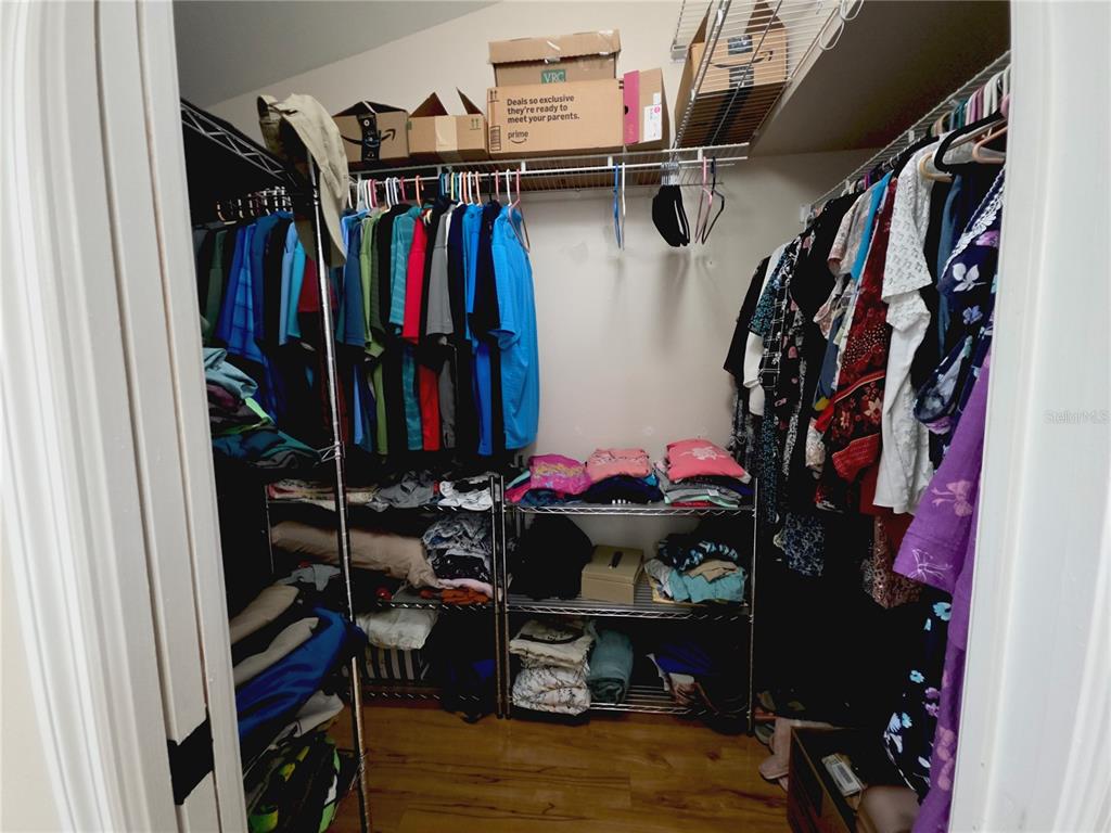 10085 Blackburn Street Spring Hill, FL 34608 - Photo 14 of 25 a view of walk in closet with clothes and shoes