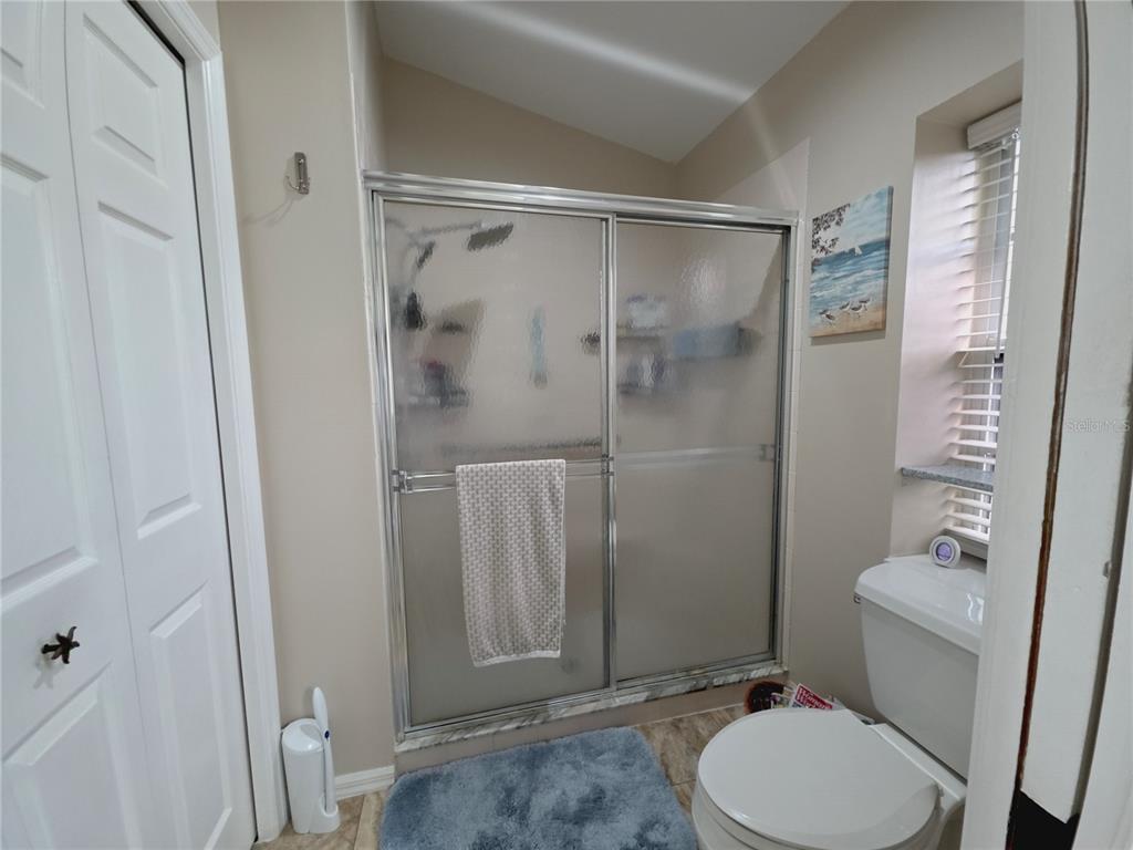 10085 Blackburn Street Spring Hill, FL 34608 - Photo 15 of 25 a bathroom with a toilet and a shower