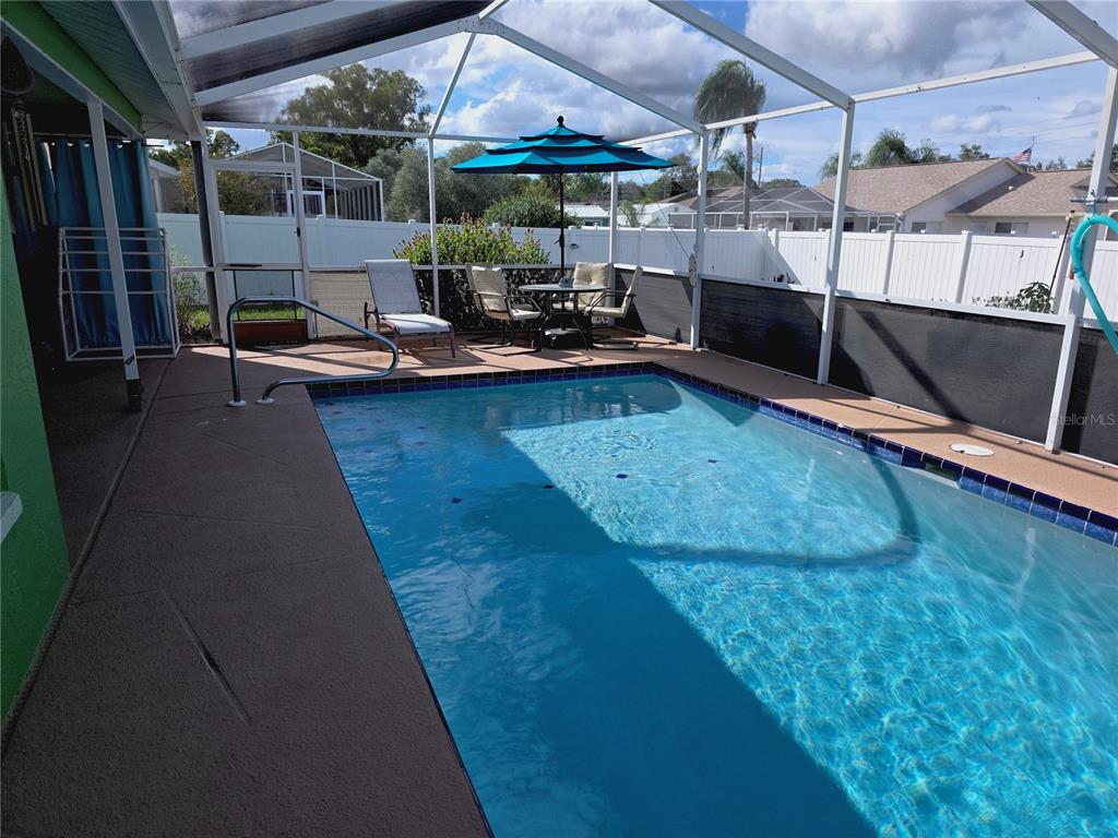 10085 Blackburn Street Spring Hill, FL 34608 - Photo 23 of 25 a view of a swimming pool with a patio