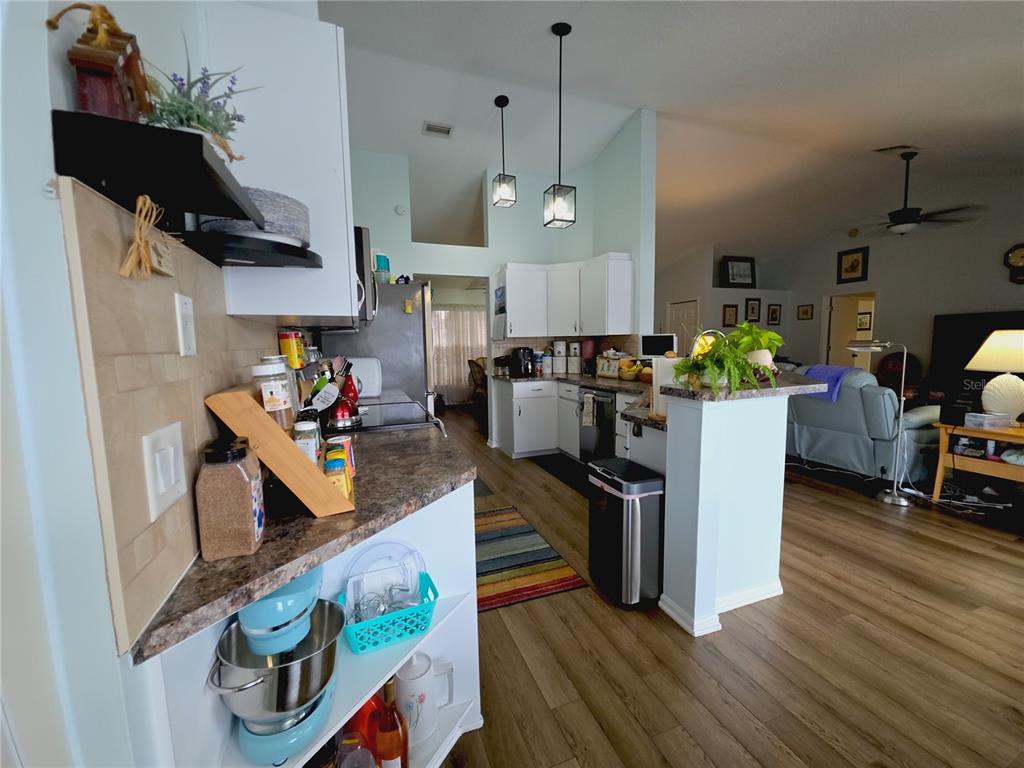 10085 Blackburn Street Spring Hill, FL 34608 - Photo 7 of 25 a living room with furniture and kitchen view