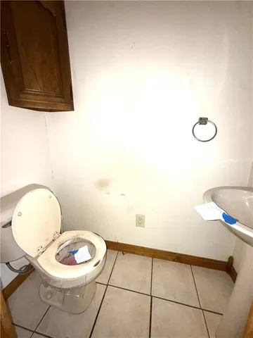 a bathroom with a toilet and a mirror