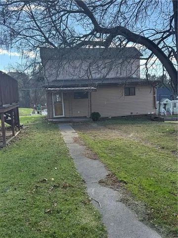 a view of a yard with a large tree