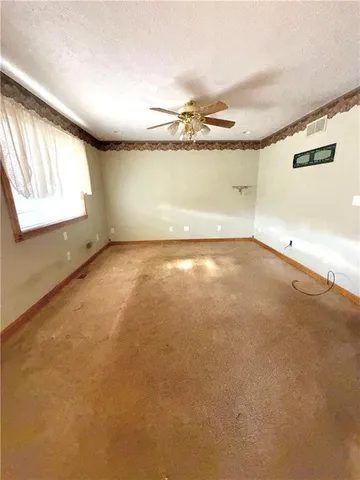 an empty room with windows and painted walls