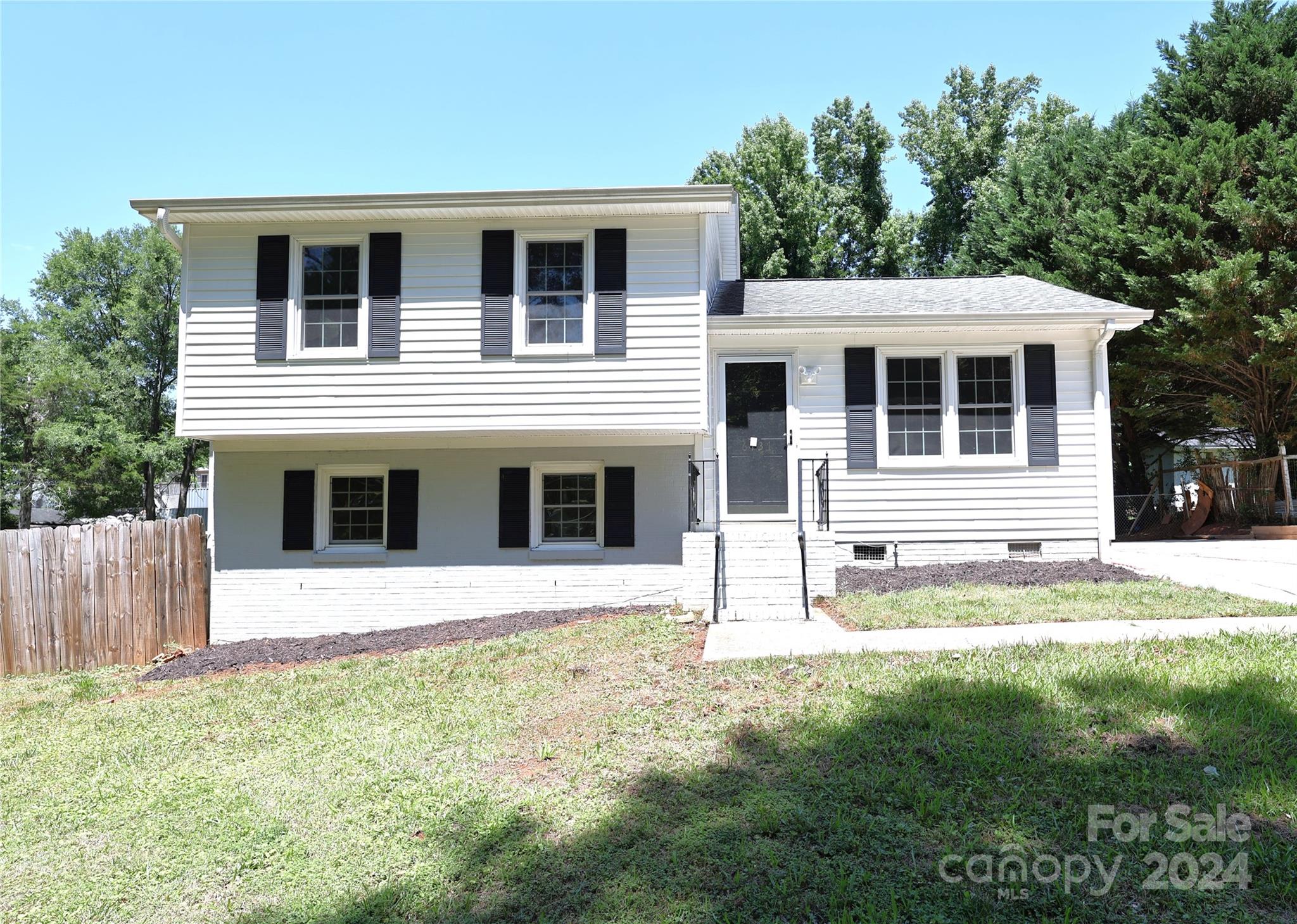 6131 Trotters Ridge Road Charlotte, NC 28227 - Photo 1 of 29 a front view of a house with a yard