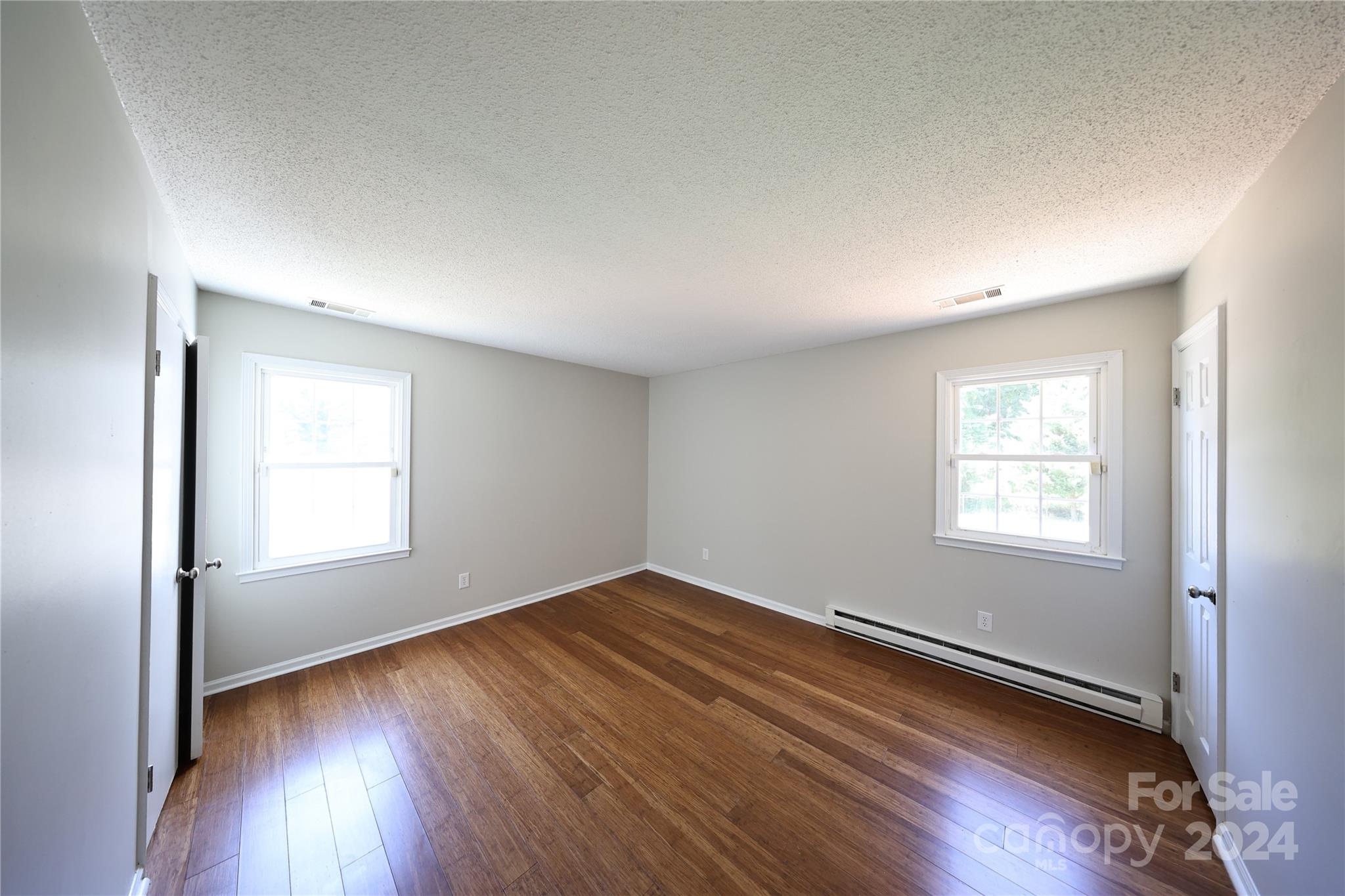 6131 Trotters Ridge Road Charlotte, NC 28227 - Photo 11 of 29 an empty room with wooden floor and windows