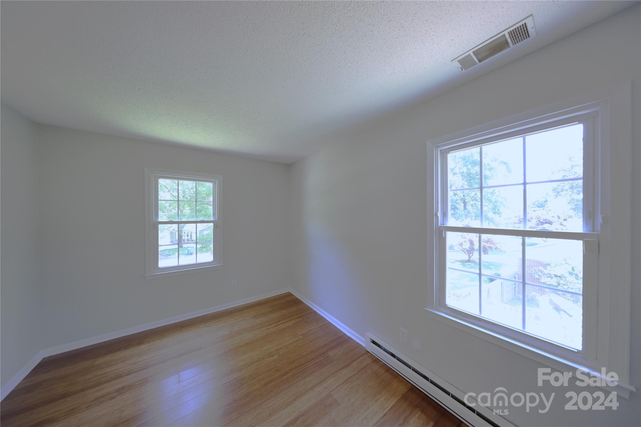 6131 Trotters Ridge Road Charlotte, NC 28227 - Photo 12 of 29 an empty room with wooden floor and windows