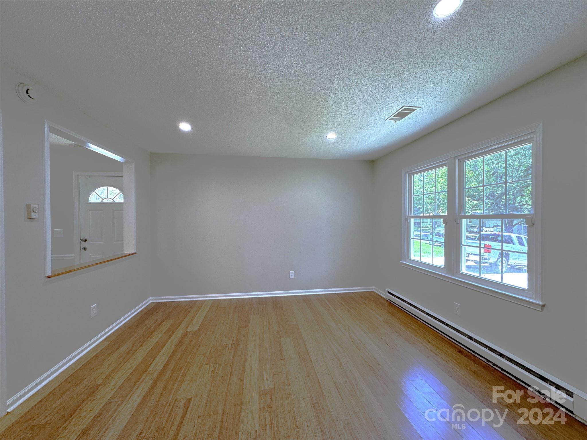 6131 Trotters Ridge Road Charlotte, NC 28227 - Photo 13 of 29 an empty room with wooden floor and windows