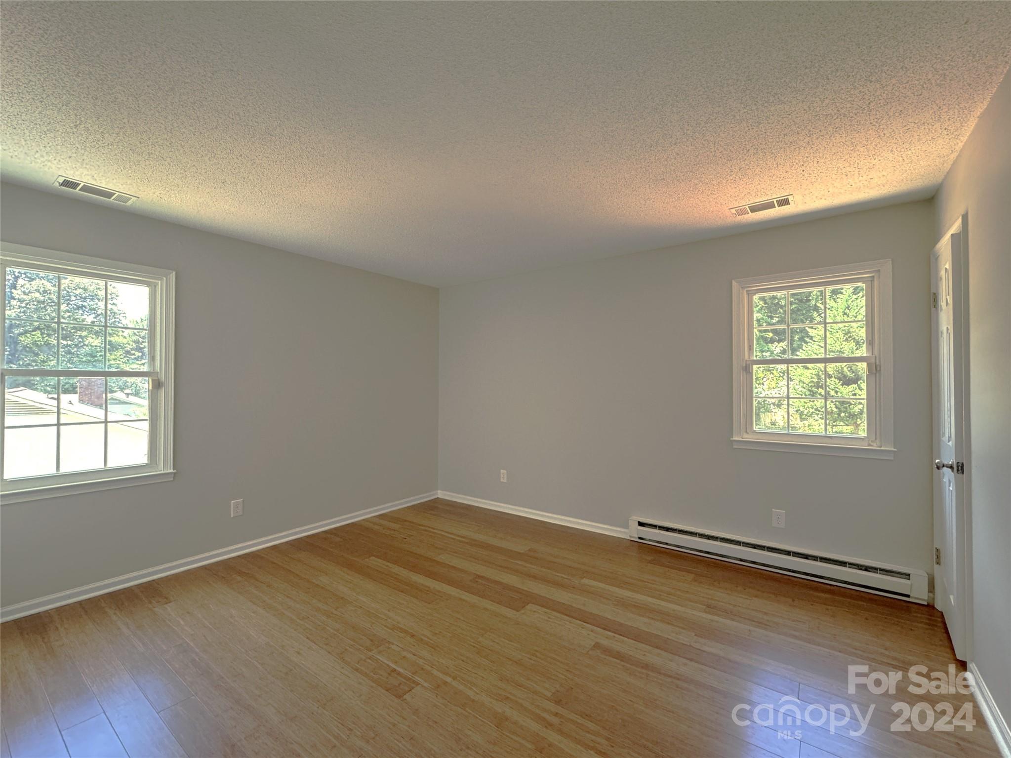 6131 Trotters Ridge Road Charlotte, NC 28227 - Photo 16 of 29 an empty room with wooden floor and windows