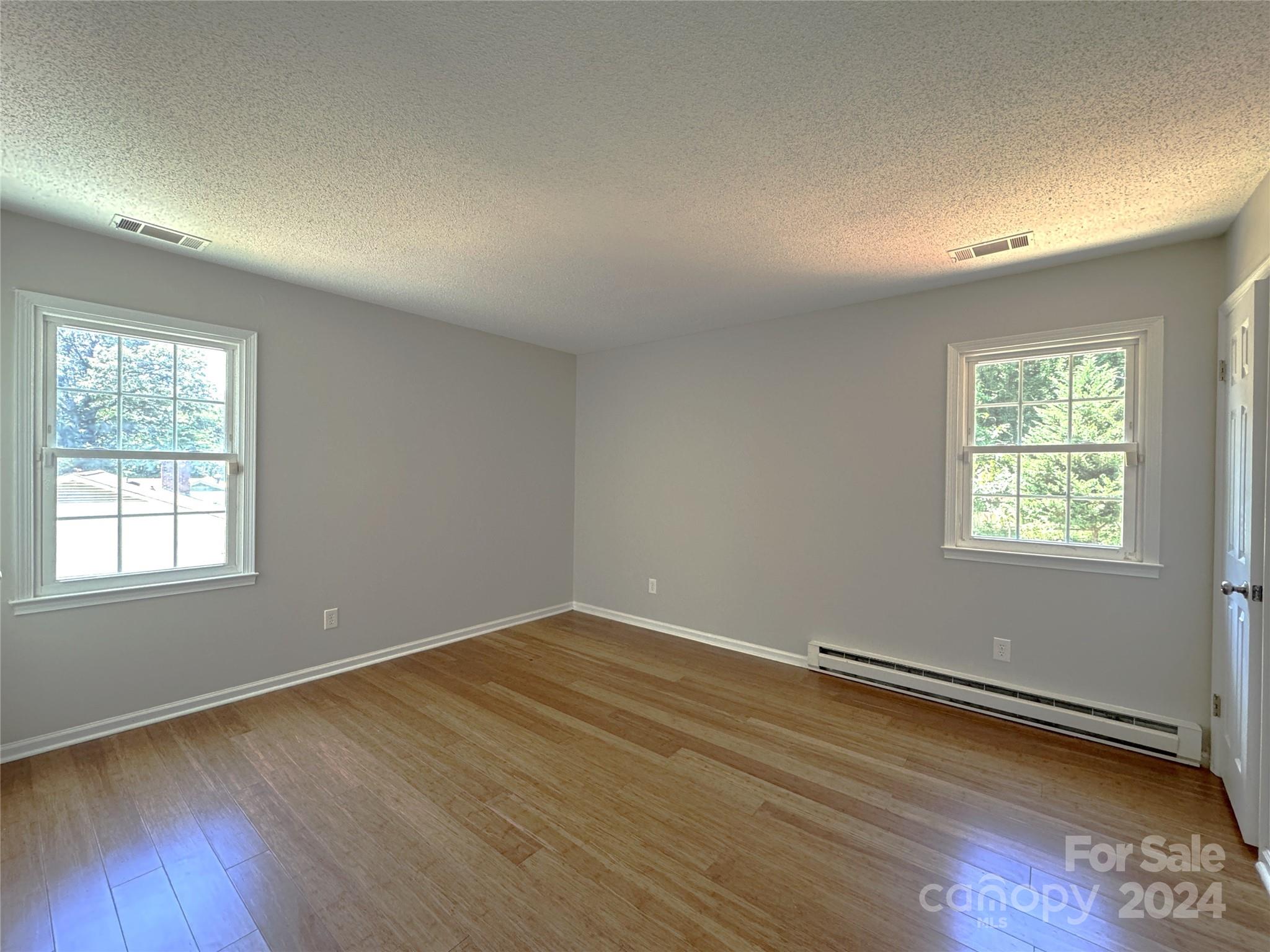 6131 Trotters Ridge Road Charlotte, NC 28227 - Photo 18 of 29 an empty room with wooden floor and windows