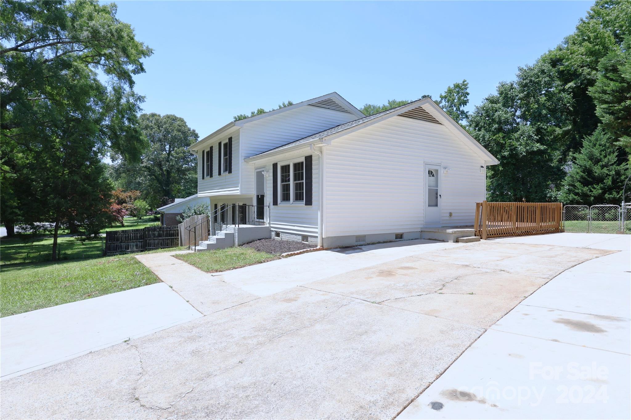 6131 Trotters Ridge Road Charlotte, NC 28227 - Photo 2 of 29 a view of a house with backyard and trees