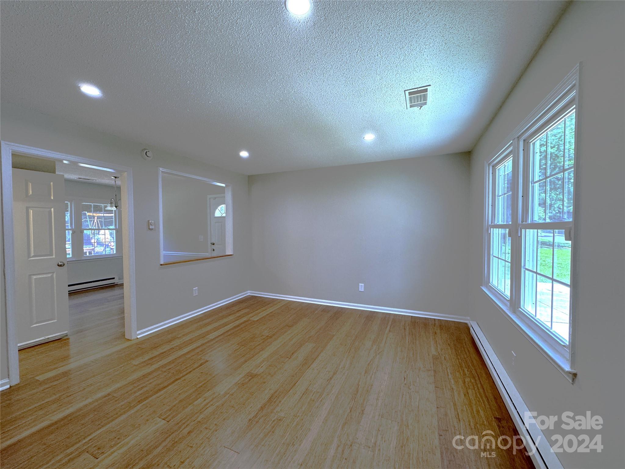 6131 Trotters Ridge Road Charlotte, NC 28227 - Photo 23 of 29 wooden floor in an empty room with a window