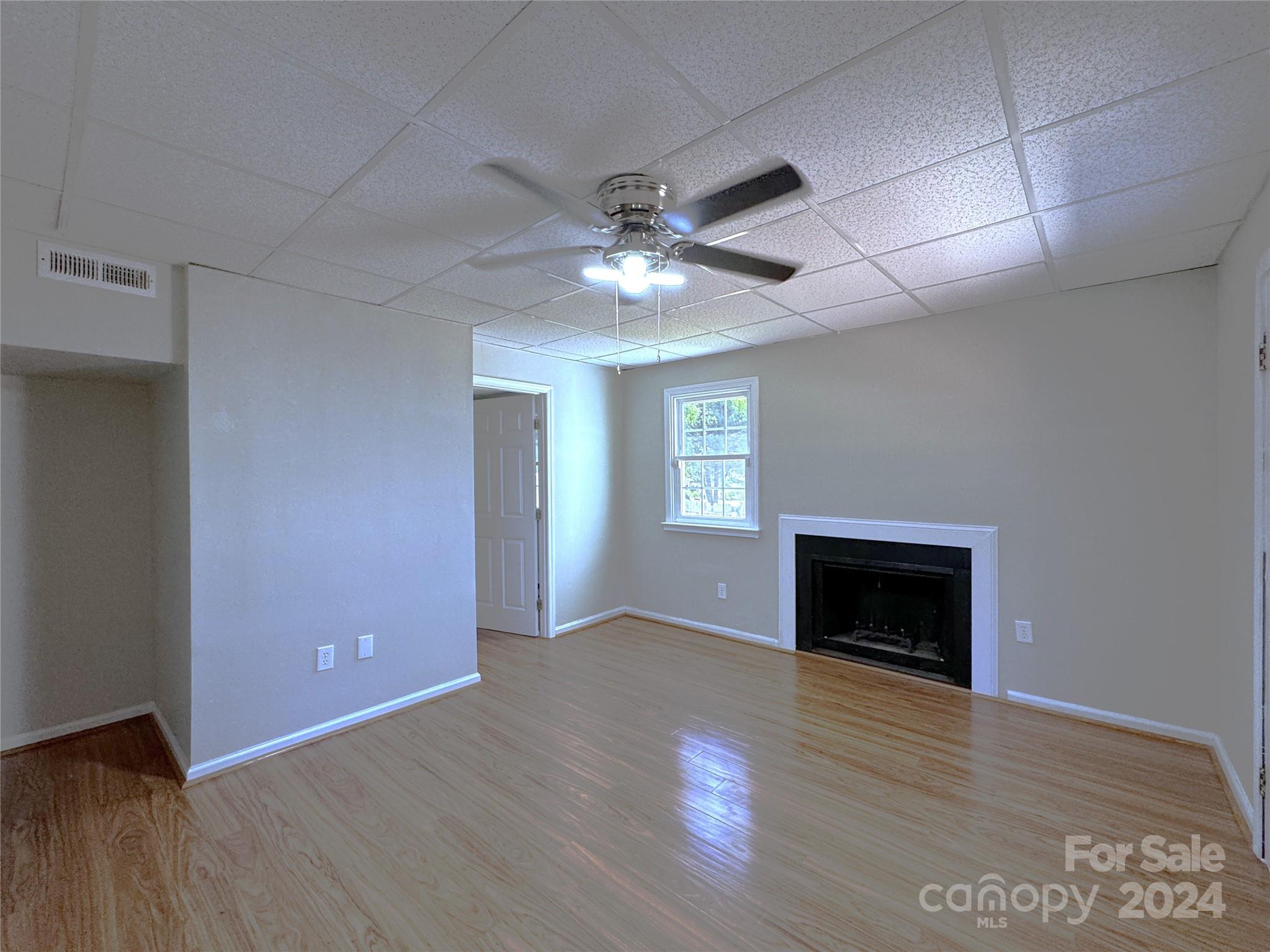 6131 Trotters Ridge Road Charlotte, NC 28227 - Photo 24 of 29 a view of an empty room with a fireplace and a window