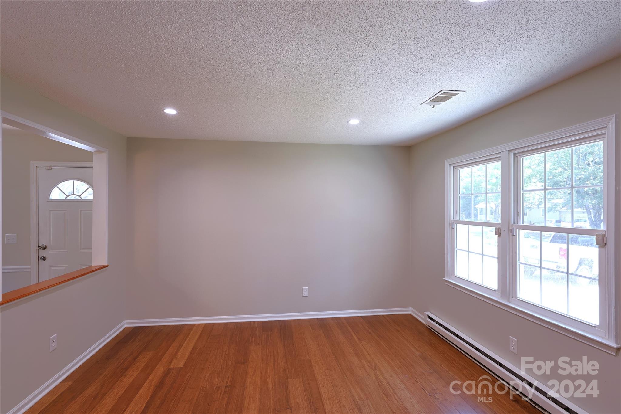6131 Trotters Ridge Road Charlotte, NC 28227 - Photo 5 of 29 an empty room with wooden floor and windows