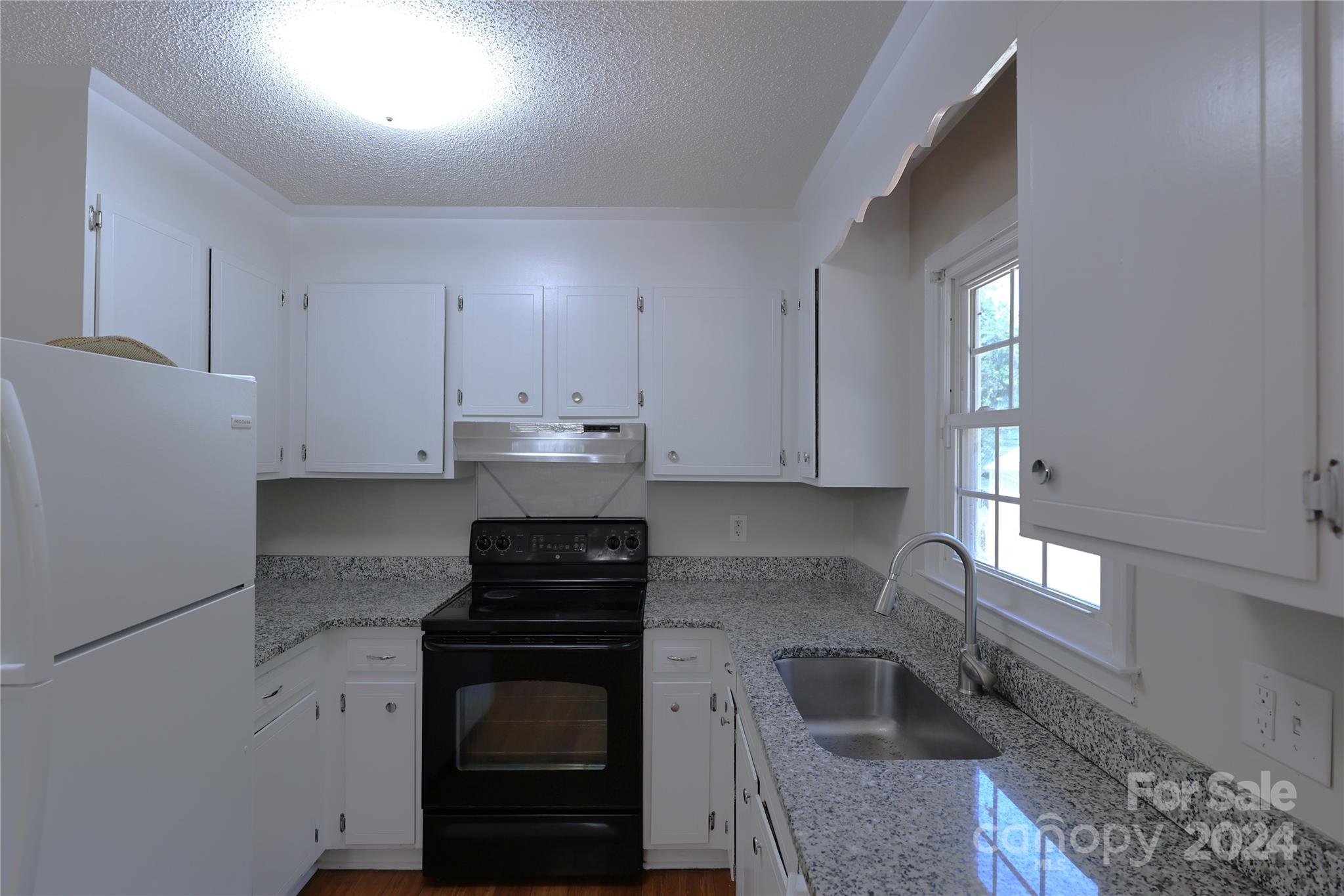 6131 Trotters Ridge Road Charlotte, NC 28227 - Photo 8 of 29 a kitchen with granite countertop white cabinets and stainless steel appliances