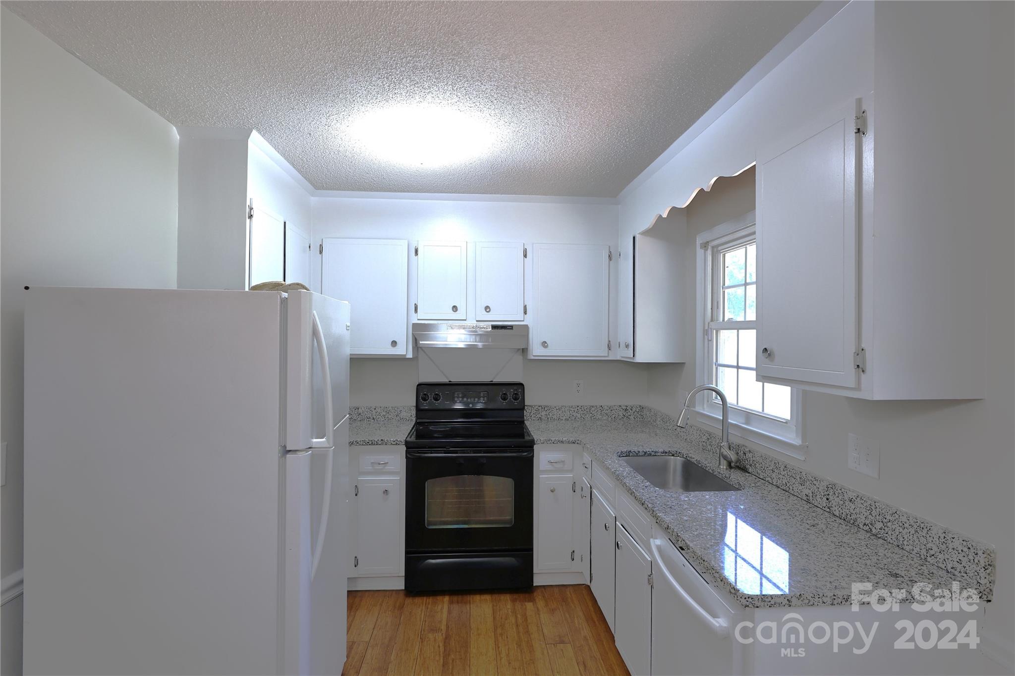 6131 Trotters Ridge Road Charlotte, NC 28227 - Photo 9 of 29 a kitchen with a refrigerator sink and stove
