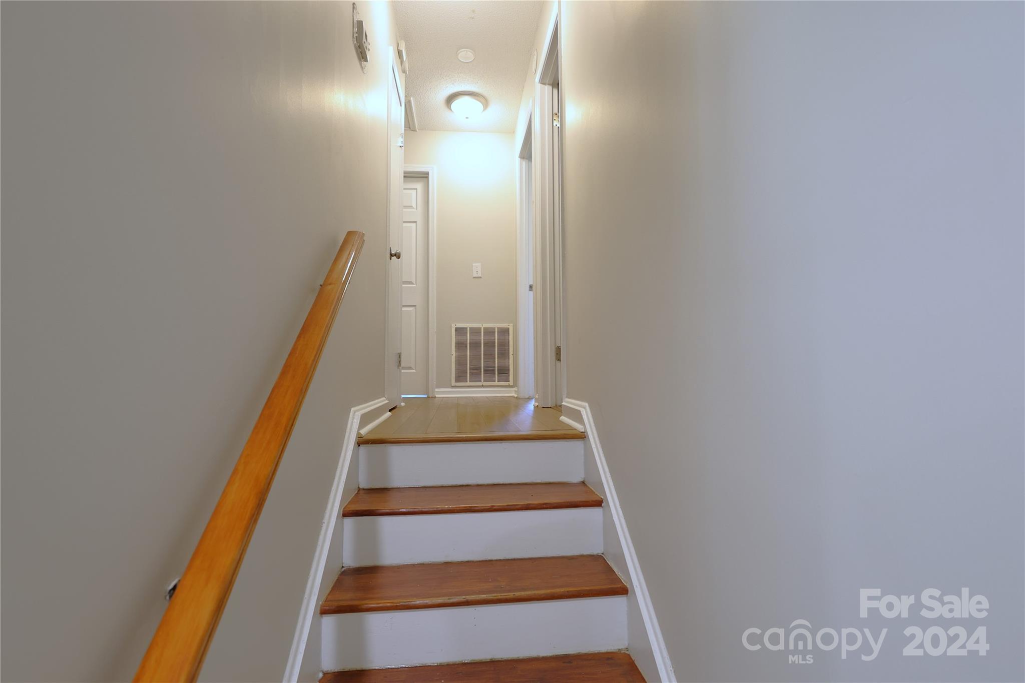 6131 Trotters Ridge Road Charlotte, NC 28227 - Photo 10 of 29 a view of staircase with white walls and white door