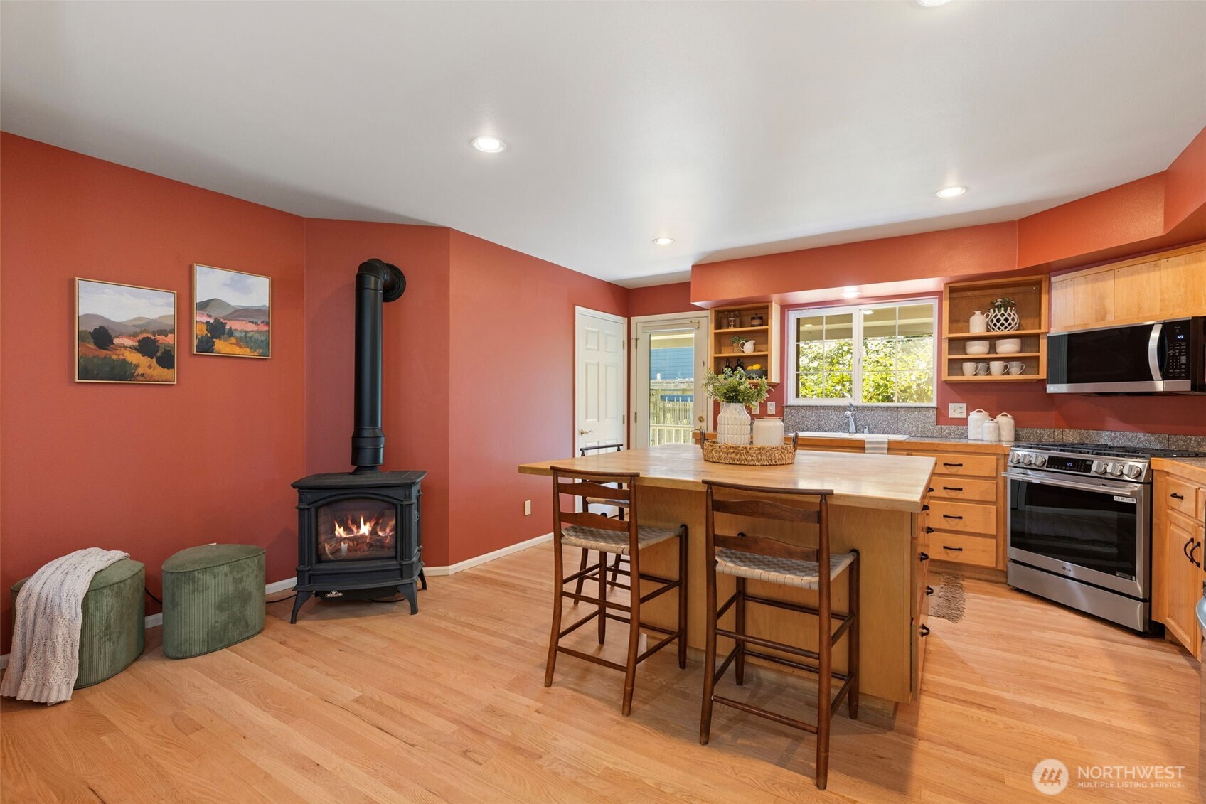 1757 Maple Street Port Townsend, WA 98368 - Photo 8 of 40 a kitchen with stainless steel appliances granite countertop a stove top oven a sink a dining table and chairs with wooden floor