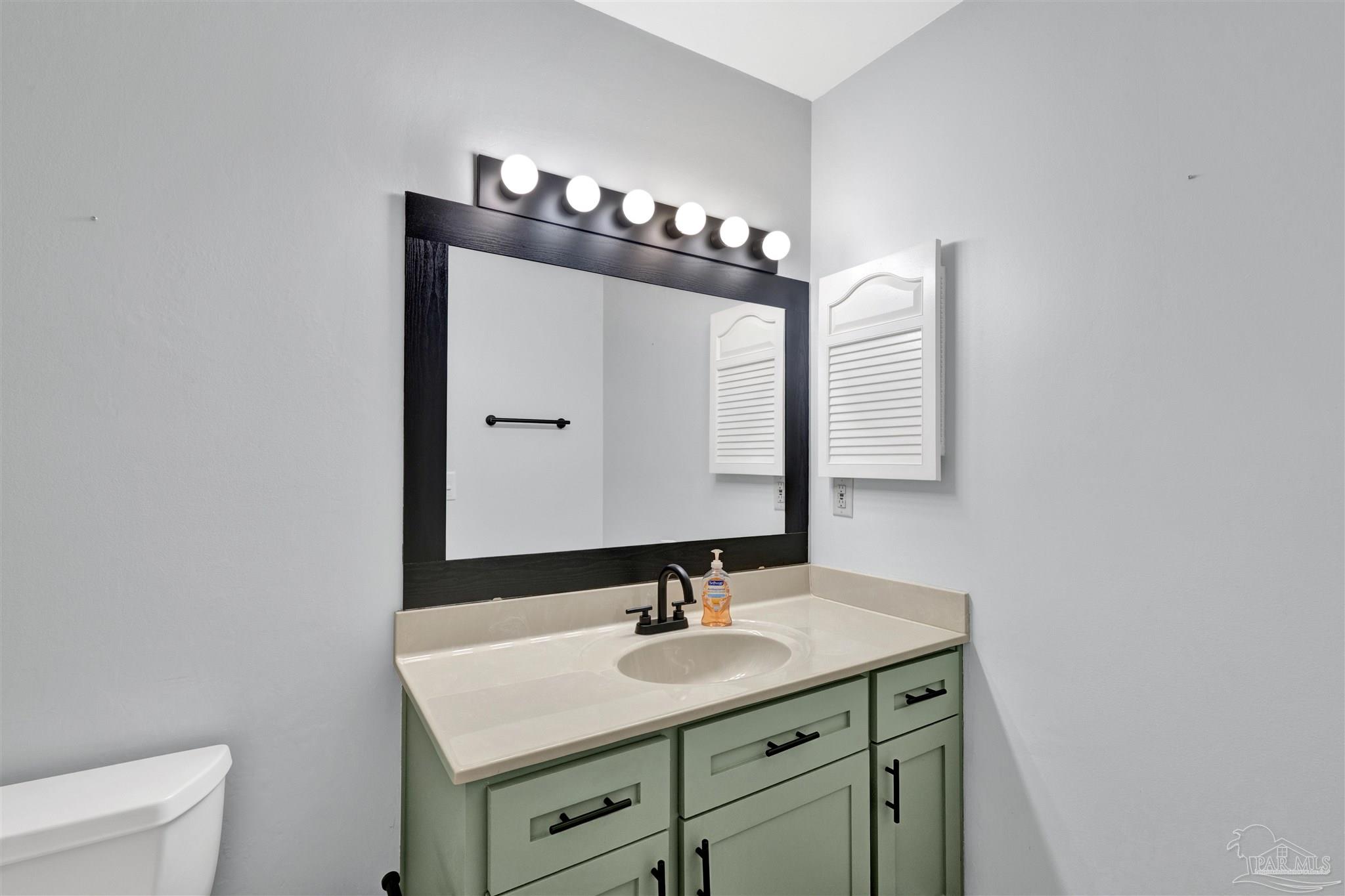14100 River Road, Unit 334 Perdido Key, FL 32507 - Photo 26 of 35 a bathroom with a sink and a mirror