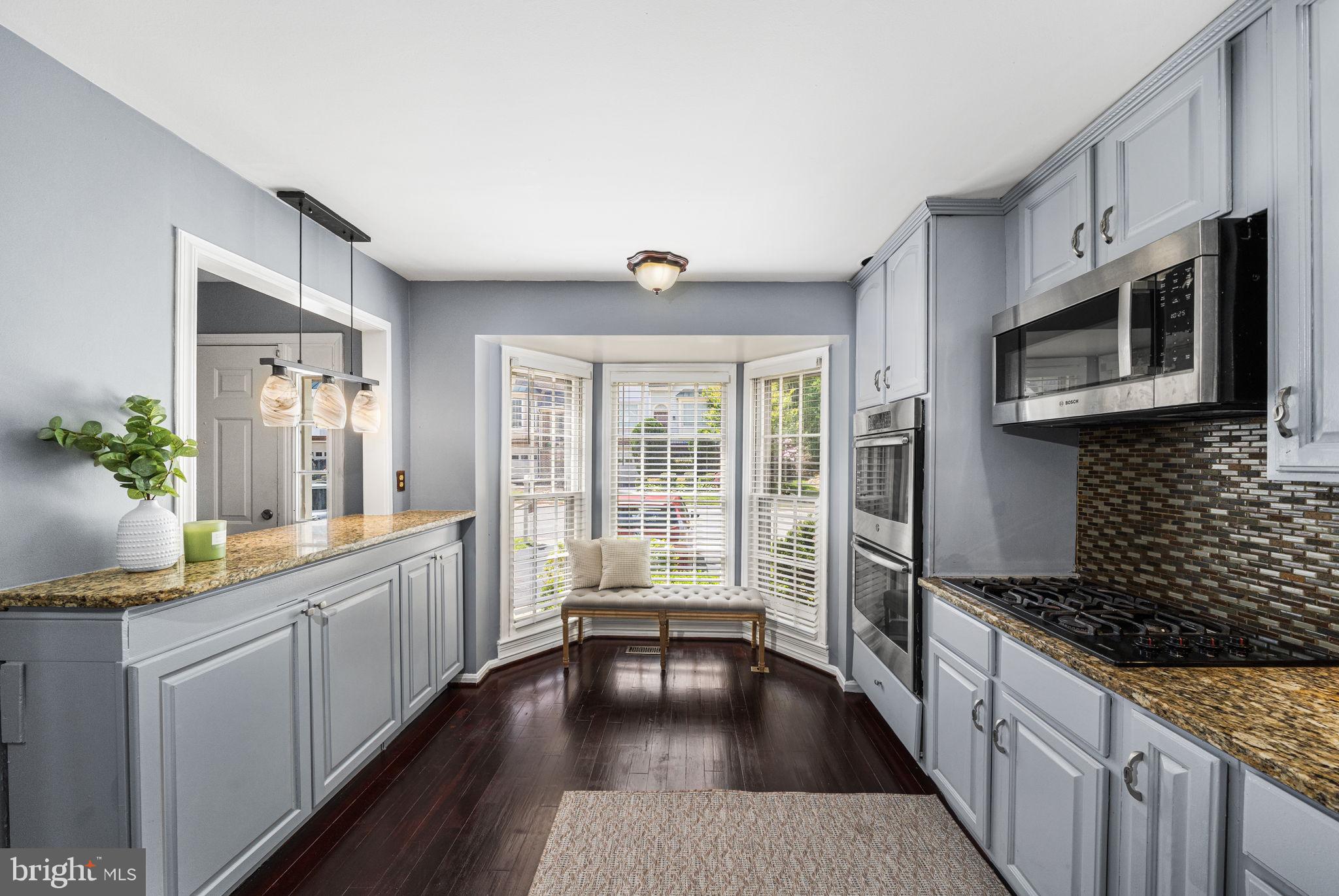 7403 Ridge Oak Court Springfield, VA 22153 - Photo 11 of 54 a kitchen with stainless steel appliances a stove sink microwave and cabinets