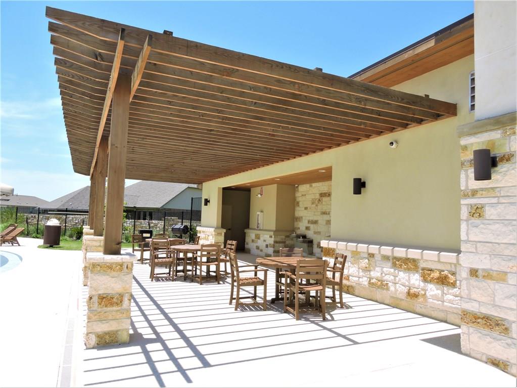 1005 Sundrops Street Leander, TX 78641 - Photo 30 of 39 a view of a patio with dining table and chairs