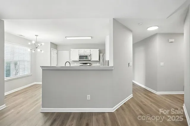 a kitchen with stainless steel appliances a refrigerator sink and microwave