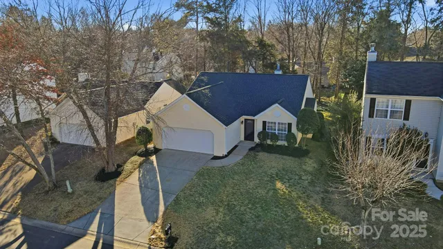 a view of house with a yard and sitting area