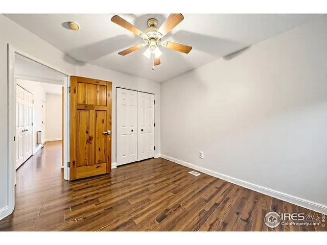 an empty room with wooden floor and door