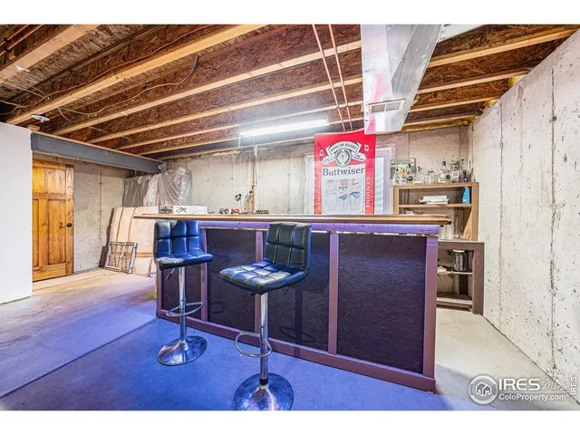 a kitchen with a refrigerator a stove and a dining table with wooden floor