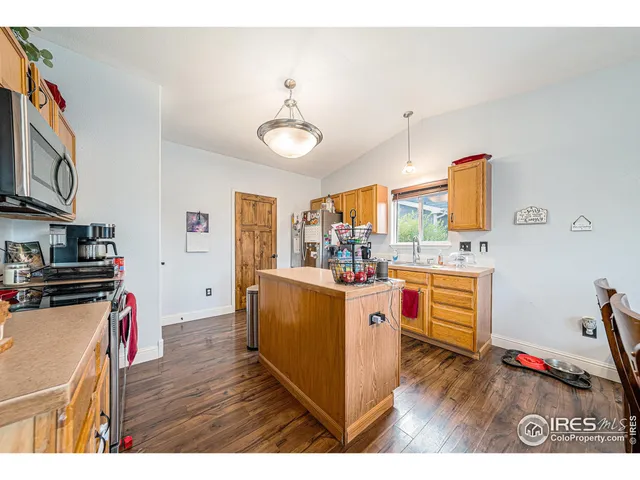 a kitchen view with stainless steel appliances granite countertop a stove and a refrigerator