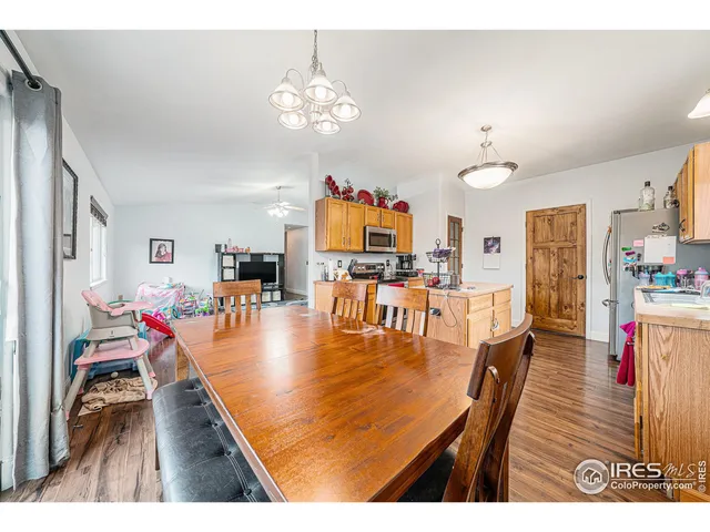 a living room with dining room and wooden floor