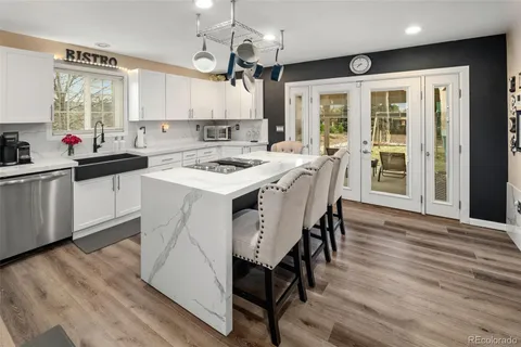 a kitchen with stainless steel appliances white cabinets and a stove
