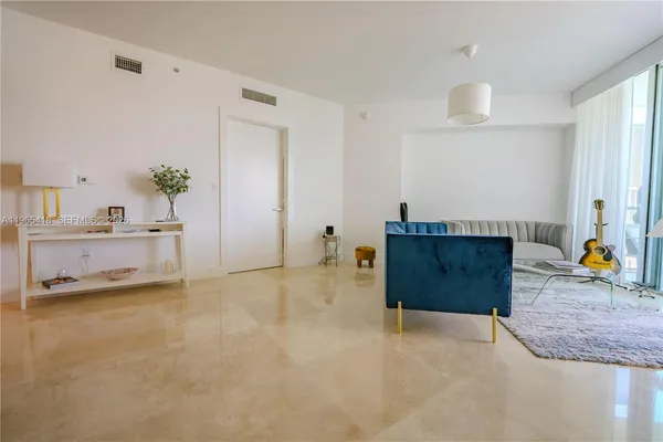 a living room with furniture and a potted plant