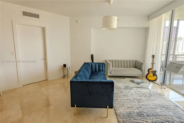 a living room with a couch and a chandelier