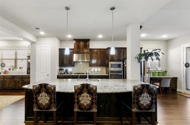 a large kitchen with cabinets and stainless steel appliances