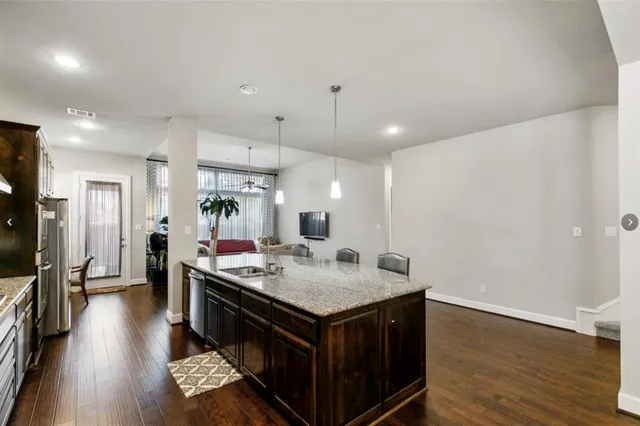 a kitchen with a stove and a wooden floor