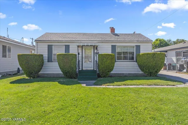 a front view of house with yard and outdoor seating