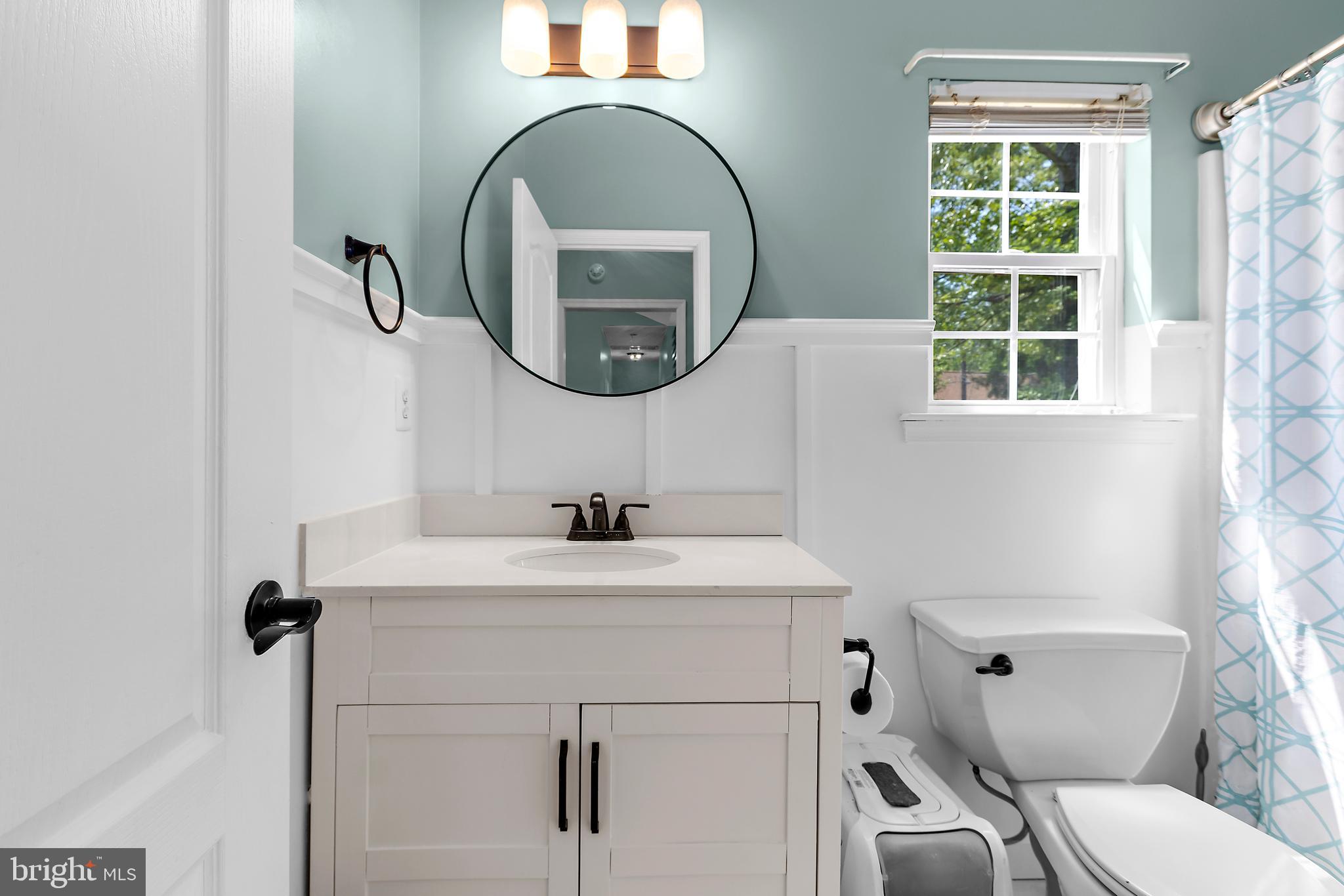 11312 Rawhide Road Lusby, MD 20657 - Photo 54 of 57 a bathroom with a toilet sink and mirror