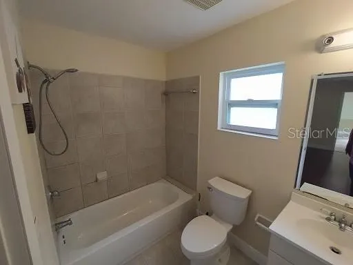 a bathroom with a toilet sink and shower