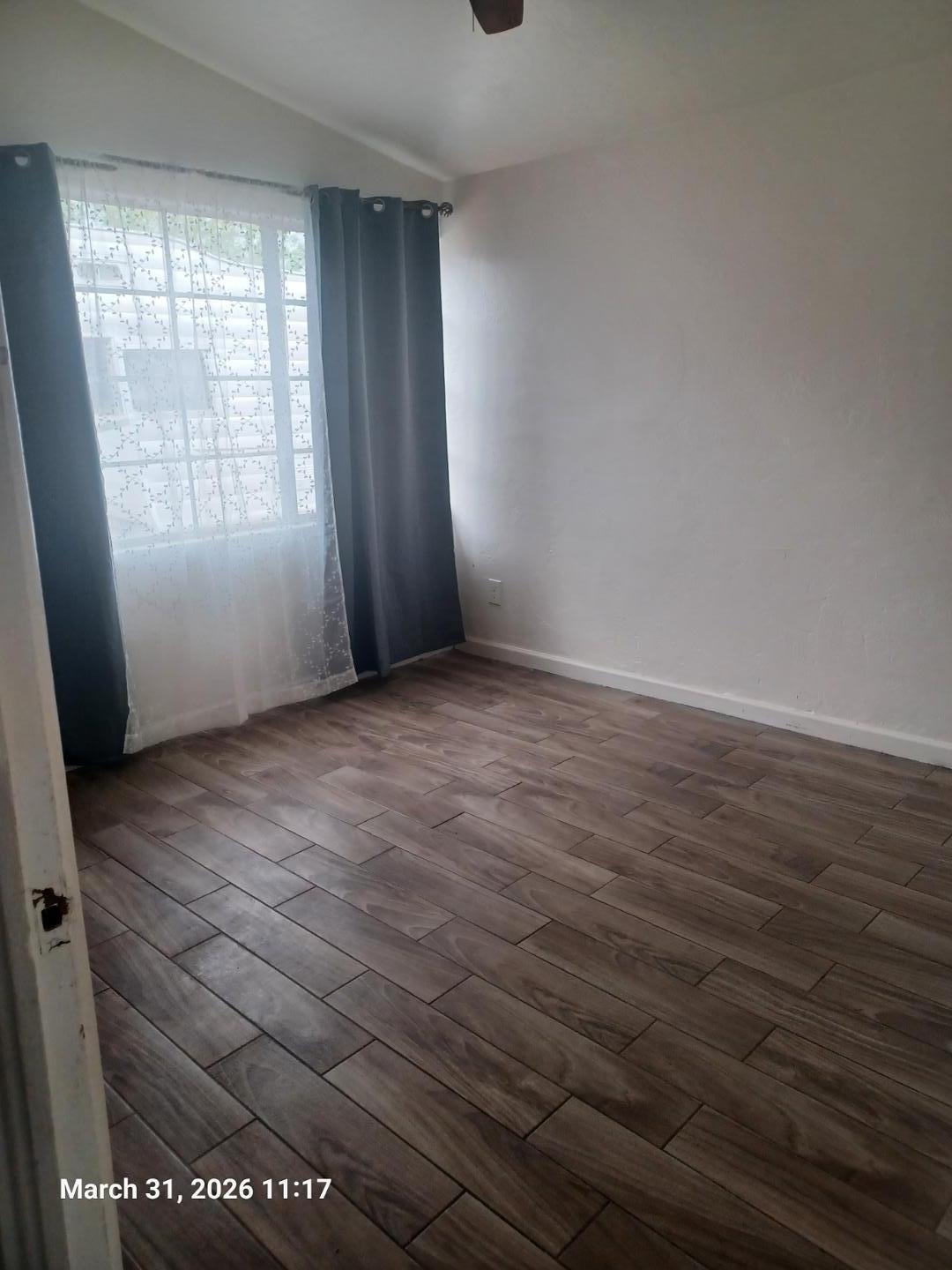 6746 North 14th Street Phoenix, AZ 85014 - Photo 6 of 9 an empty room with wooden floor and windows