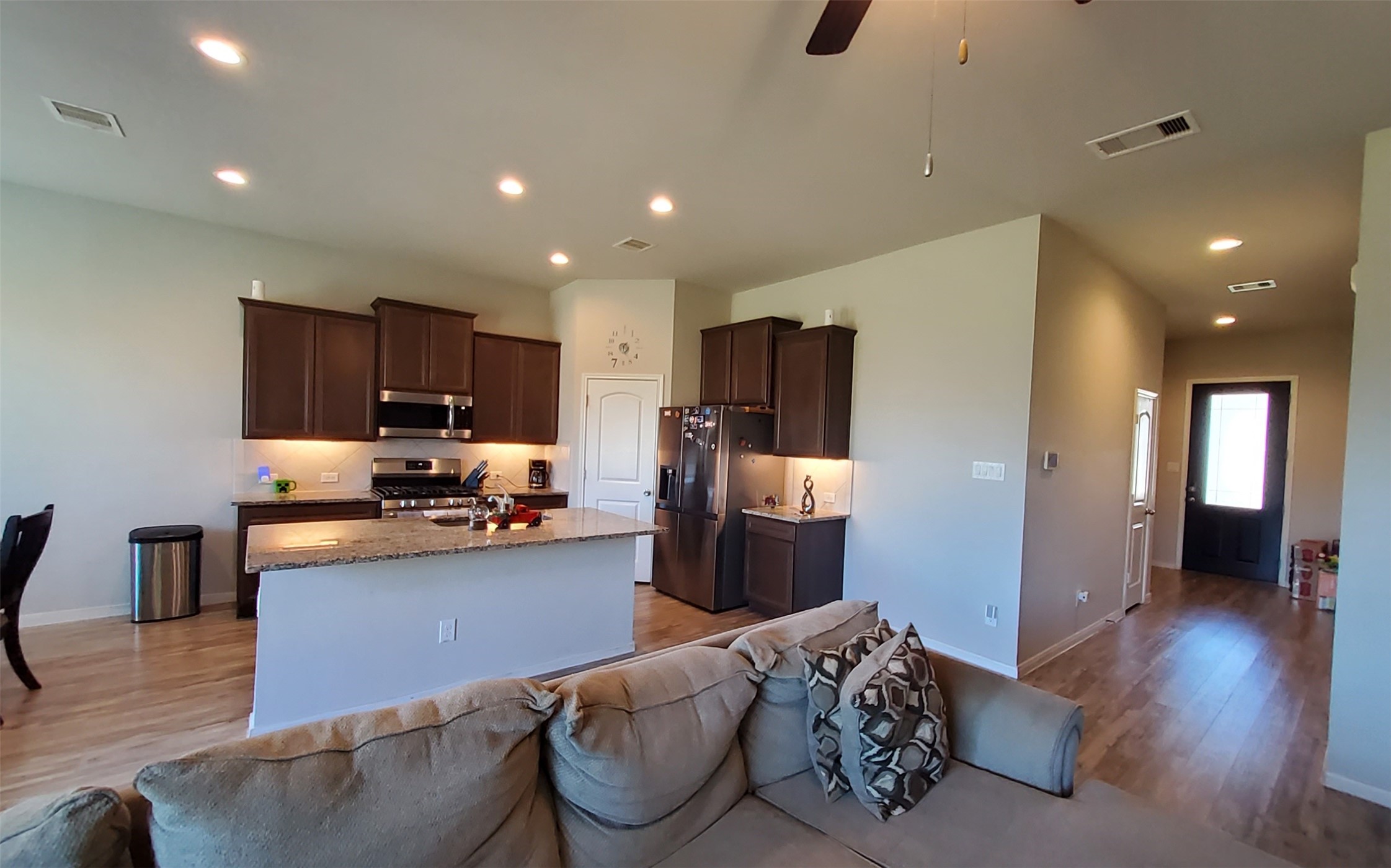 24418 Hollow Gate Meadow Court Spring, TX 77389 - Photo 11 of 45 a kitchen with stainless steel appliances kitchen island granite countertop a refrigerator and a sink