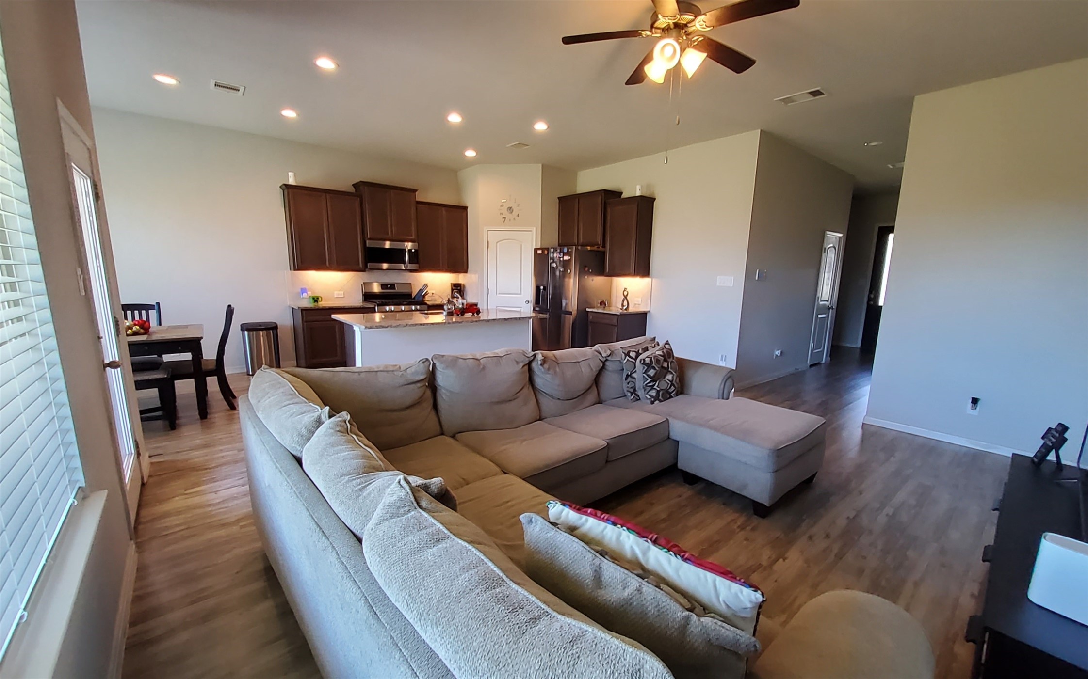 24418 Hollow Gate Meadow Court Spring, TX 77389 - Photo 12 of 45 a living room with furniture kitchen view and a chandelier