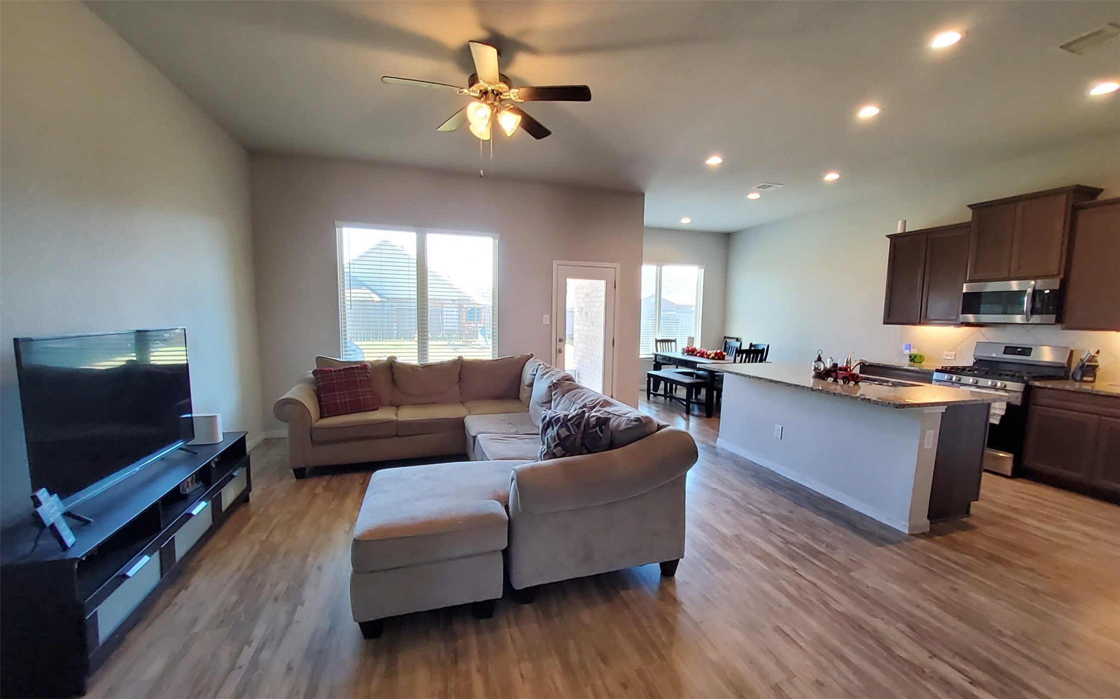 24418 Hollow Gate Meadow Court Spring, TX 77389 - Photo 14 of 45 a living room with furniture and a flat screen tv