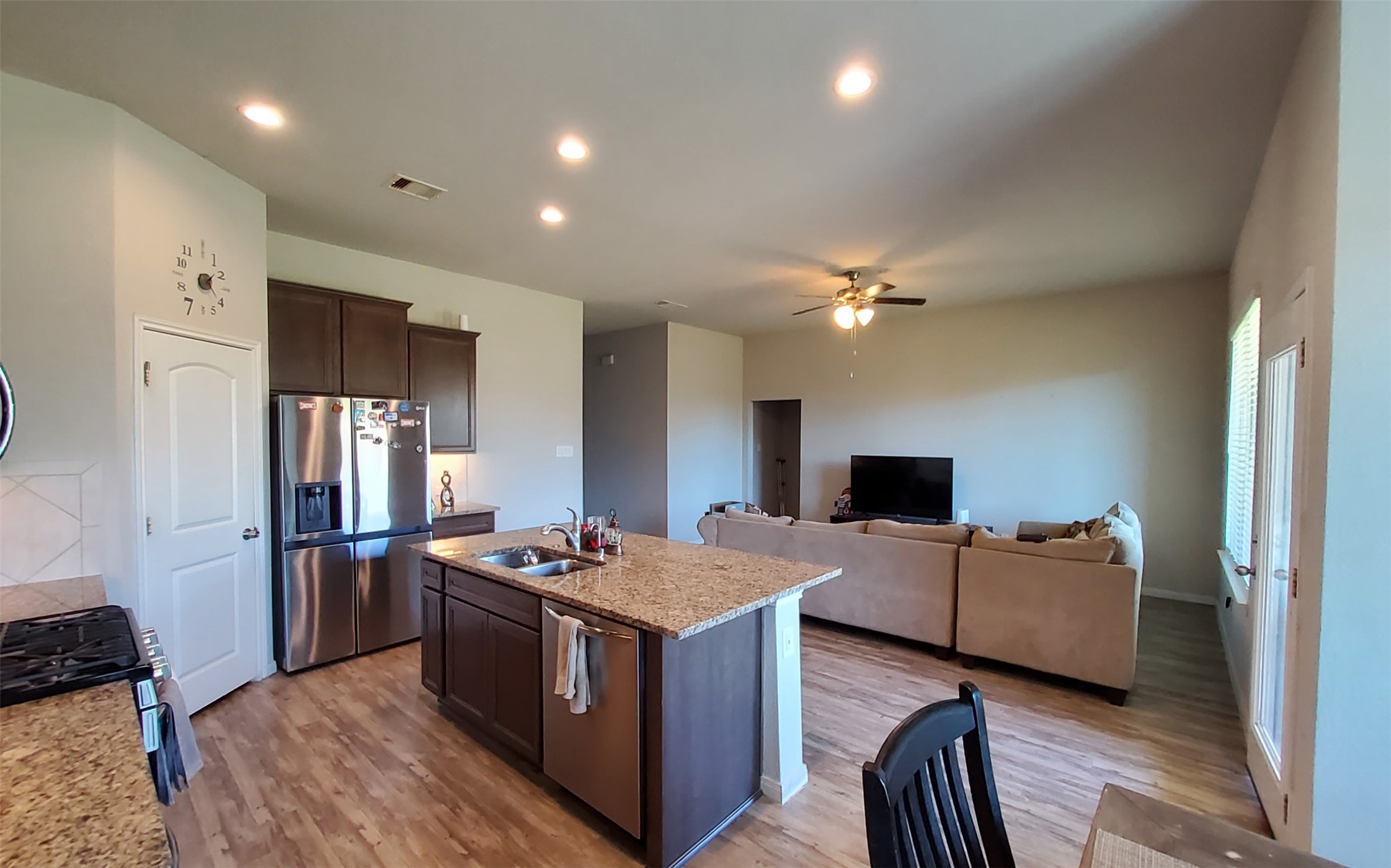 24418 Hollow Gate Meadow Court Spring, TX 77389 - Photo 16 of 45 a kitchen with a refrigerator and a stove top oven