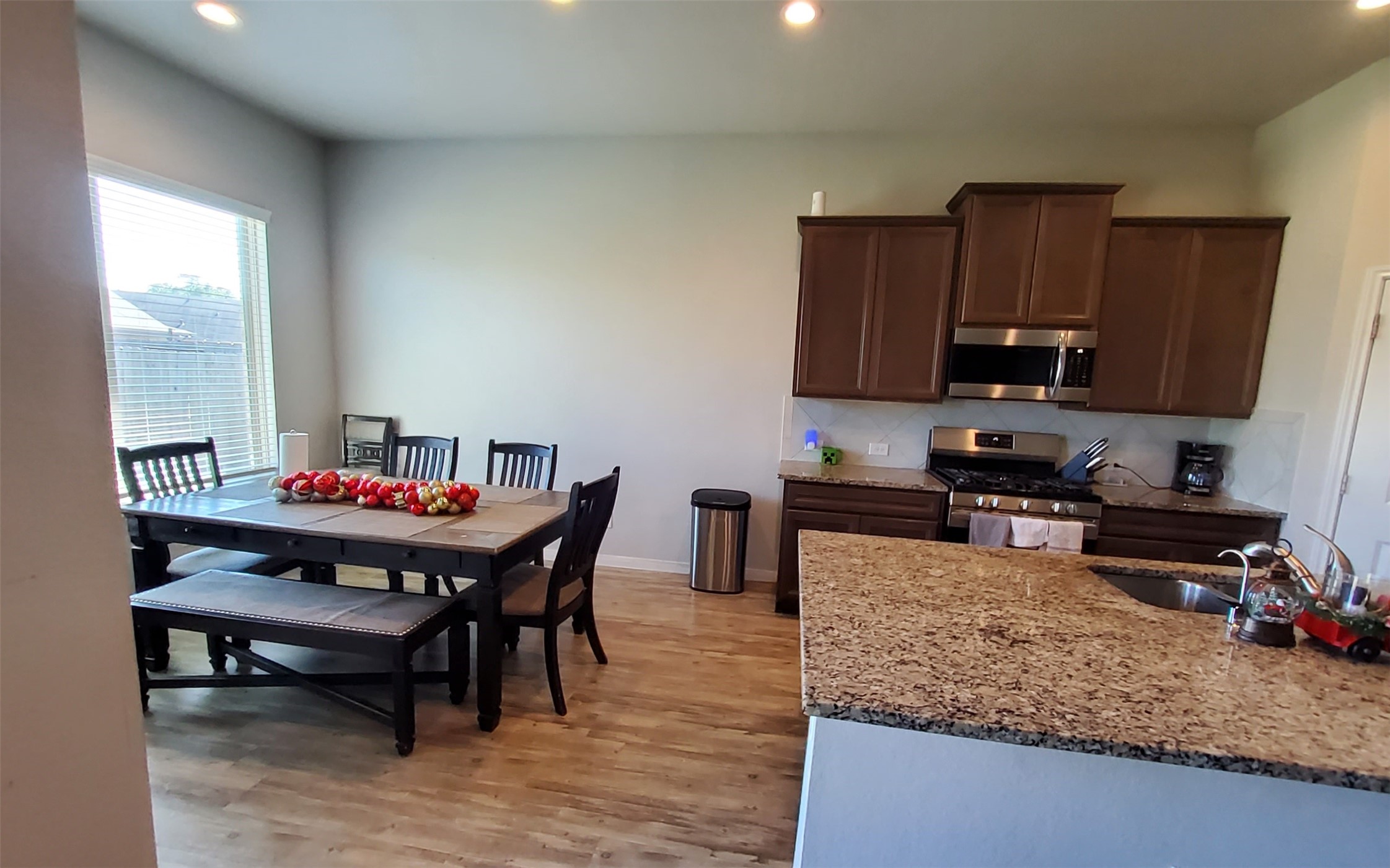 24418 Hollow Gate Meadow Court Spring, TX 77389 - Photo 18 of 45 a kitchen with a stove a sink and a refrigerator