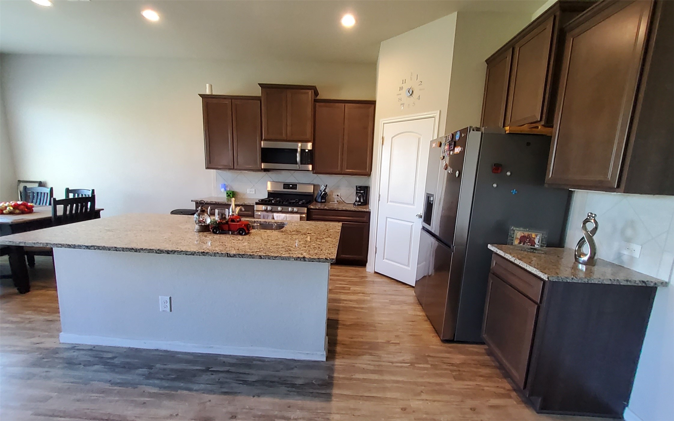 24418 Hollow Gate Meadow Court Spring, TX 77389 - Photo 19 of 45 a kitchen with granite countertop a refrigerator stove top oven and sink