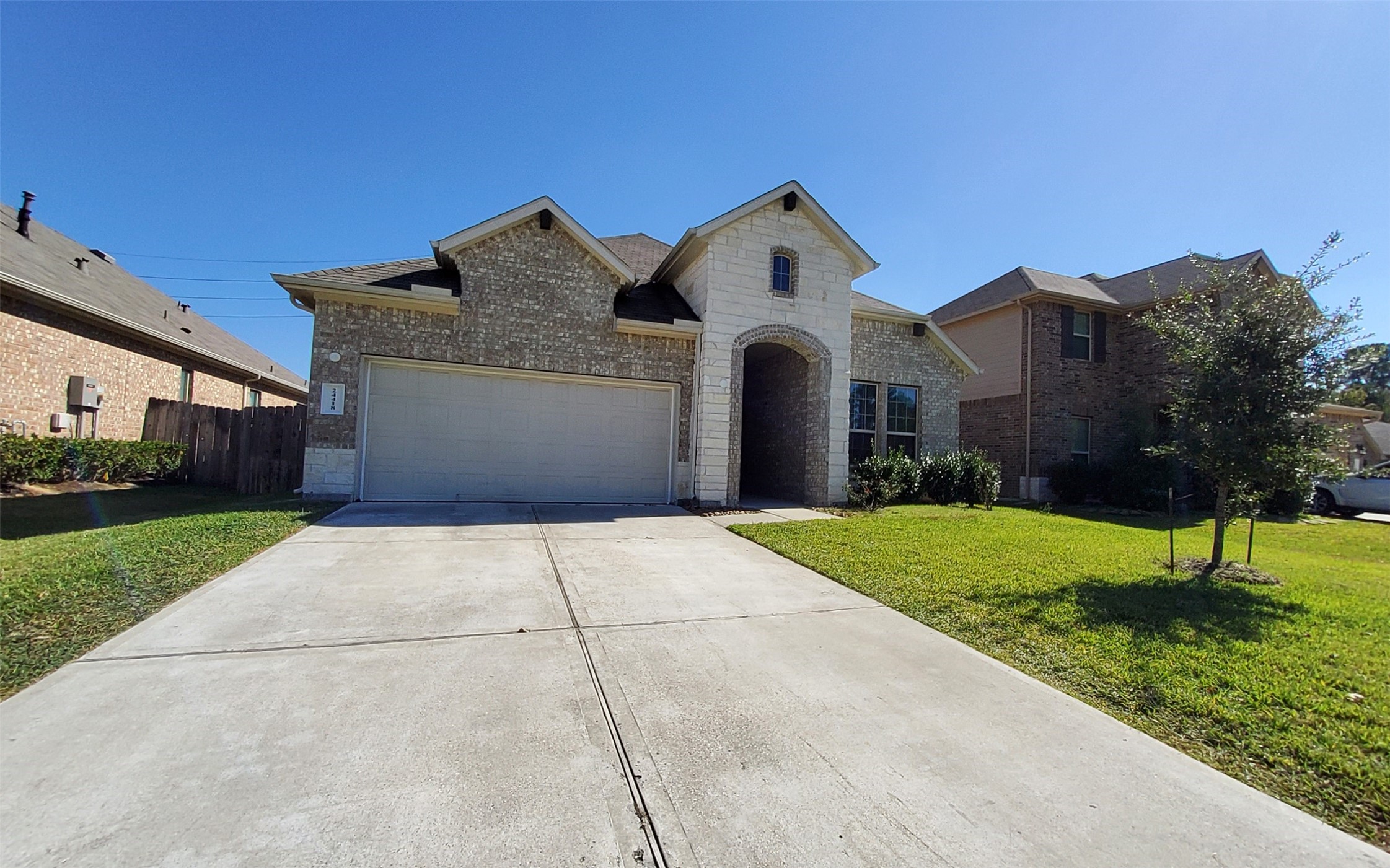 24418 Hollow Gate Meadow Court Spring, TX 77389 - Photo 2 of 45 a front view of a house with a yard and garage