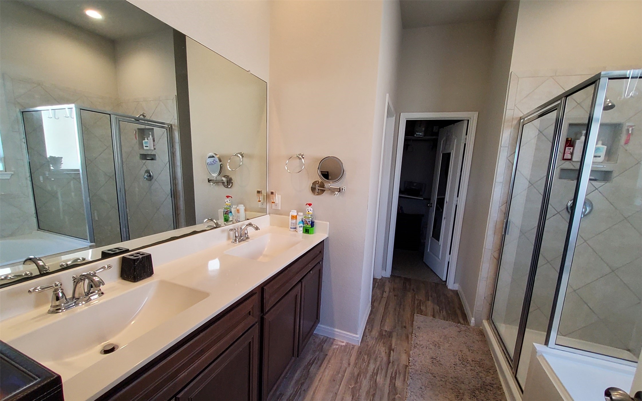 24418 Hollow Gate Meadow Court Spring, TX 77389 - Photo 24 of 45 a bathroom with a sink a mirror and a shower
